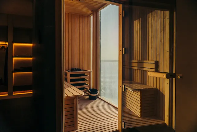 A timber-lined sauna with warm lighting.