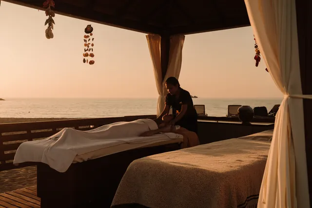 A beachside massage cabana at sunset.